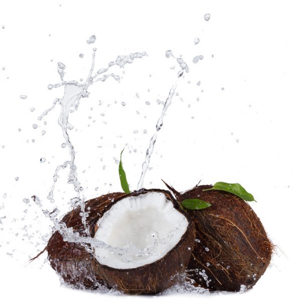 Isolated shot of cracked coconuts with water splash on white background